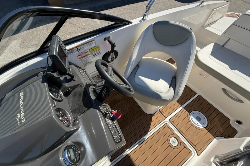 Slide: The Image of 2016 Bayliner VR5 Bowrider I/O cockpit with steering wheel, gauges, and seating. - 10