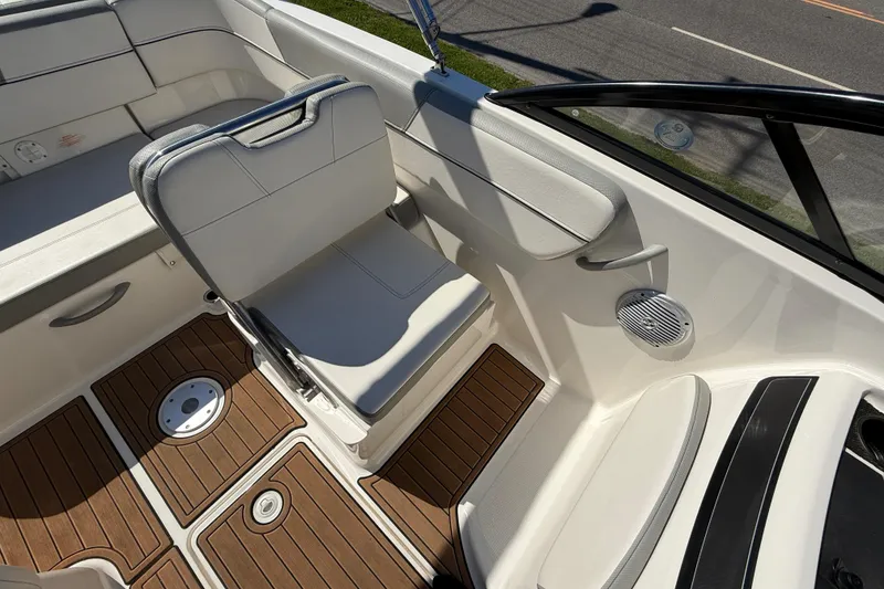 Slide: The Image of 2016 Bayliner VR5 Bowrider I/O interior with white seating and wood-patterned flooring. - 11