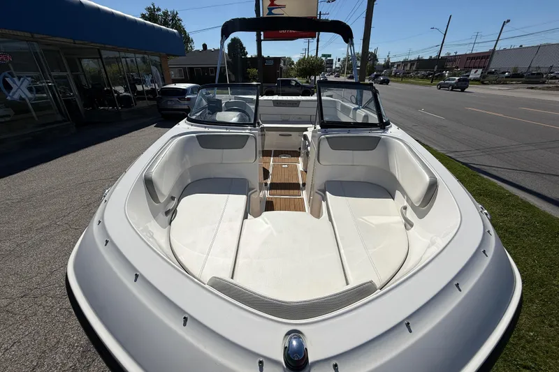 Slide: The Image of 2016 Bayliner VR5 Bowrider I/O boat with spacious seating, parked outdoors on a sunny day. - 12