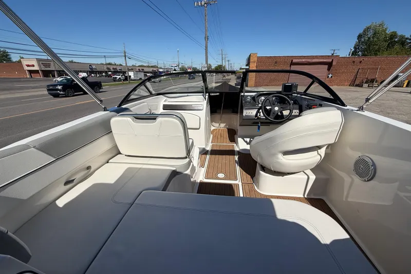 Slide: The Image of 2016 Bayliner VR5 Bowrider I/O interior with white seating and wood accents. - 13