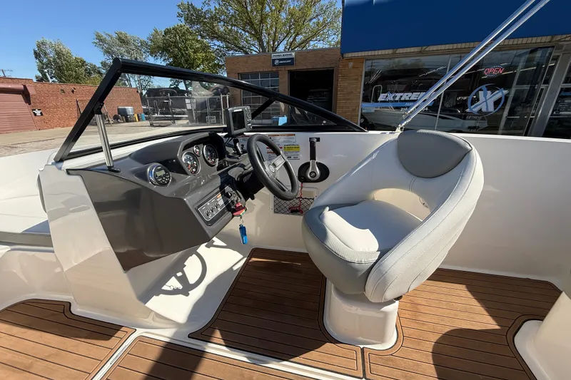 Slide: The Image of 2016 Bayliner VR5 Bowrider I/O cockpit with steering wheel and comfortable seating. - 15