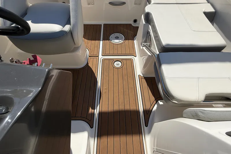 Slide: The Image of 2016 Bayliner VR5 Bowrider I/O interior with teak flooring and white seating. - 18