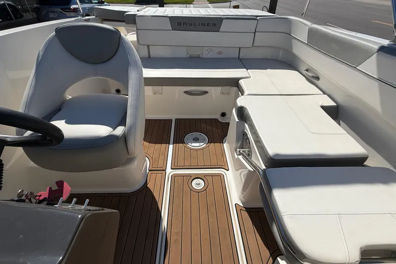 Slide: The Image of 2016 Bayliner VR5 Bowrider I/O interior with white seating and wood-style flooring. - 19