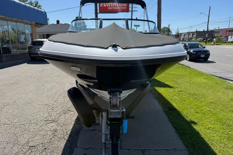 Slide: The Image of 2016 Bayliner VR5 Bowrider I/O boat on trailer, parked outdoors. - 2