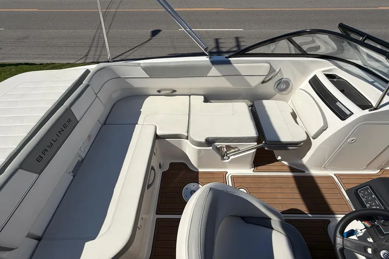 Slide: The Image of 2016 Bayliner VR5 Bowrider I/O interior with white seating and wood flooring. - 22