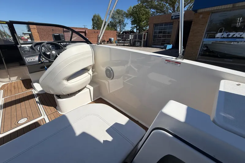 Slide: The Image of 2016 Bayliner VR5 Bowrider I/O interior with white seating and wood accents. - 23