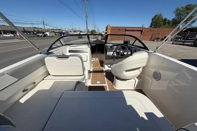 Slide: The Image of 2016 Bayliner VR5 Bowrider I/O interior with white seating and wood accents. - 25