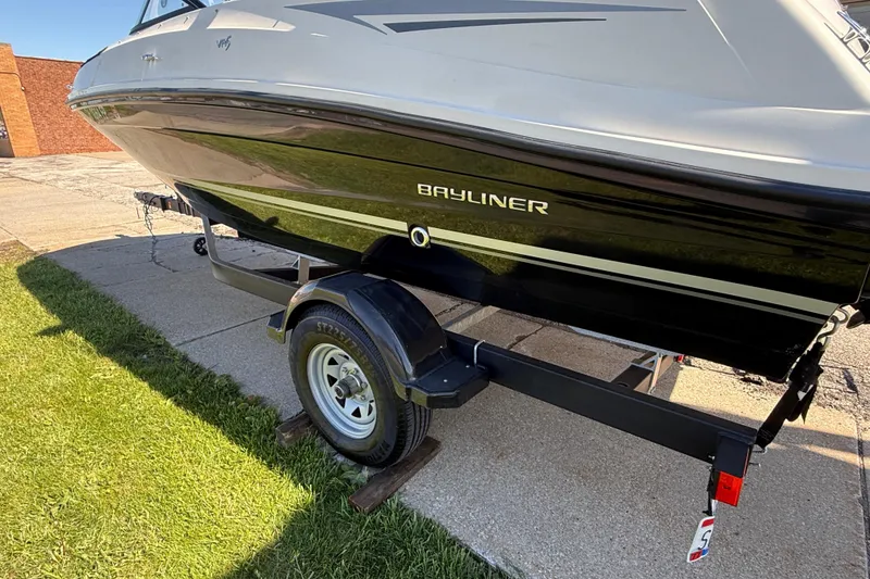 Slide: The Image of 2016 Bayliner VR5 Bowrider I/O on trailer, parked on concrete and grass. - 4