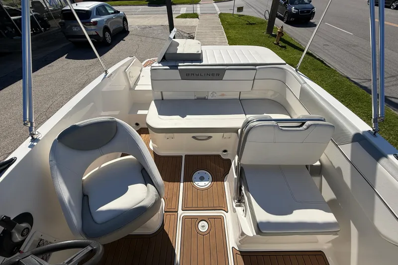Slide: The Image of 2016 Bayliner VR5 Bowrider I/O interior with white seating and wood flooring. - 7