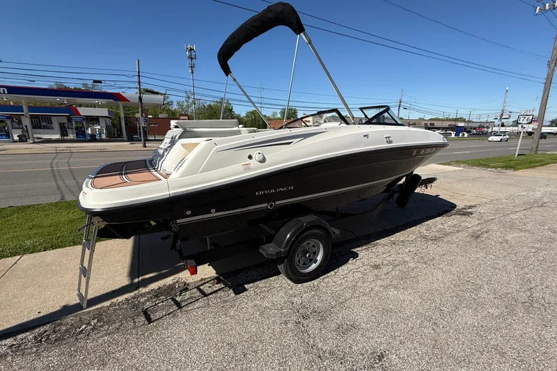 Slide: The Image of 2016 Bayliner VR5 Bowrider I/O boat on trailer, parked near a road. - 8