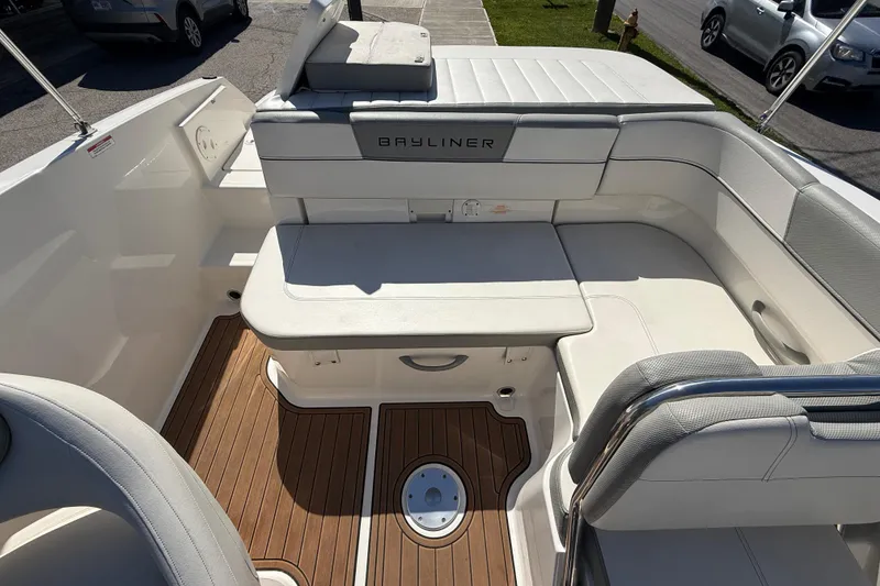 Slide: The Image of 2016 Bayliner VR5 Bowrider I/O interior with white seating and wood-style flooring. - 9