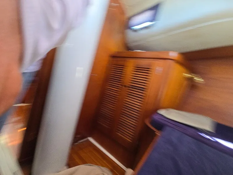 Slide: The Image of Interior of a 1995 Freedom sloop with wooden cabinetry. - 12