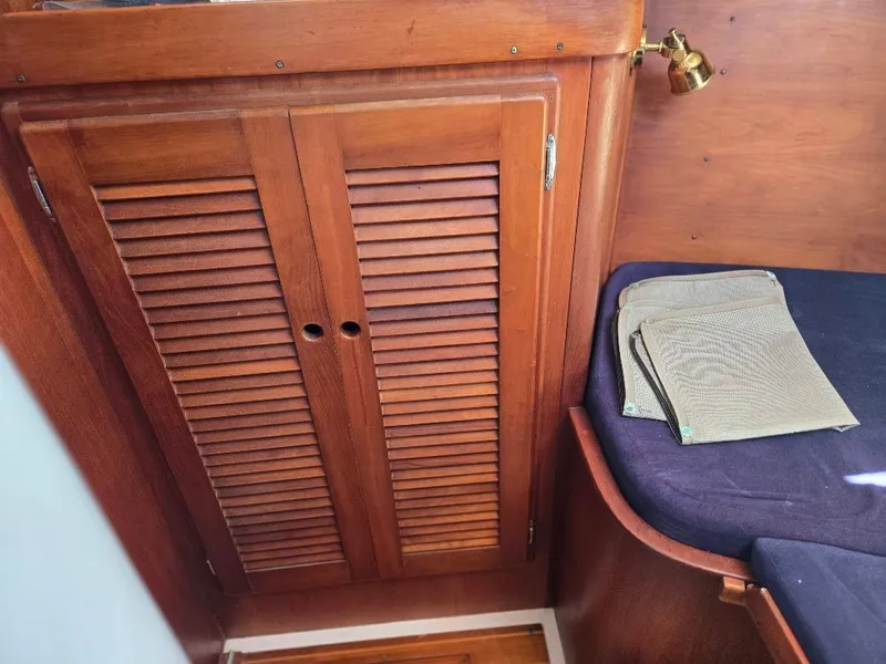 Slide: The Image of Interior of a 1995 Freedom sloop with wooden furniture and seating area. - 15