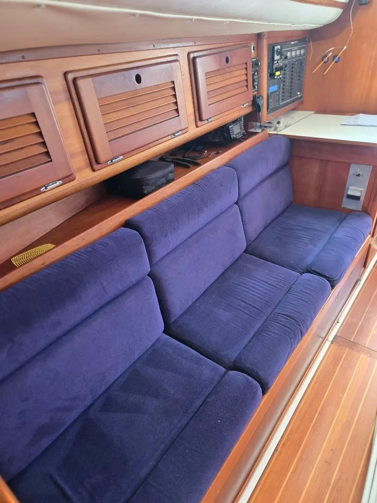 Slide: The Image of Interior of a 1995 Freedom sloop with blue cushions. - 16