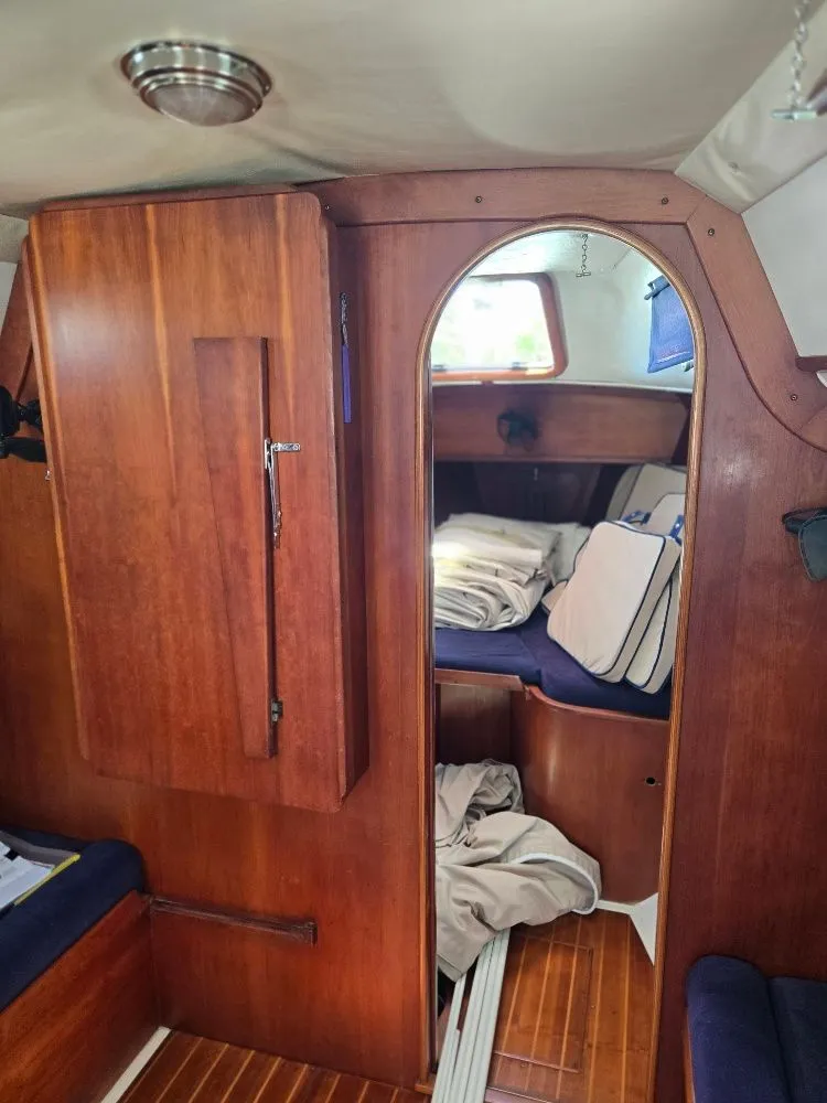 Slide: The Image of Interior of a 1995 Freedom sloop with wooden furnishings. - 17