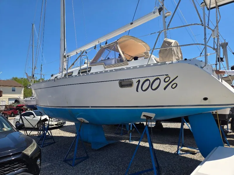 Slide: The Image of 1995 Freedom Sloop displayed on stands outdoors. - 2