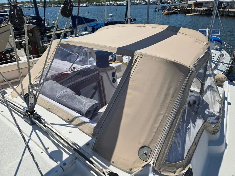 Slide: The Image of 1995 Freedom sloop with canopy docked at marina. - 23