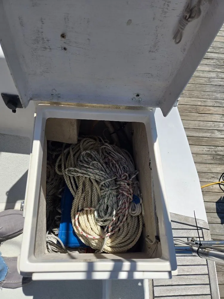 Slide: The Image of Open storage compartment on 1995 Freedom sloop with ropes. - 24