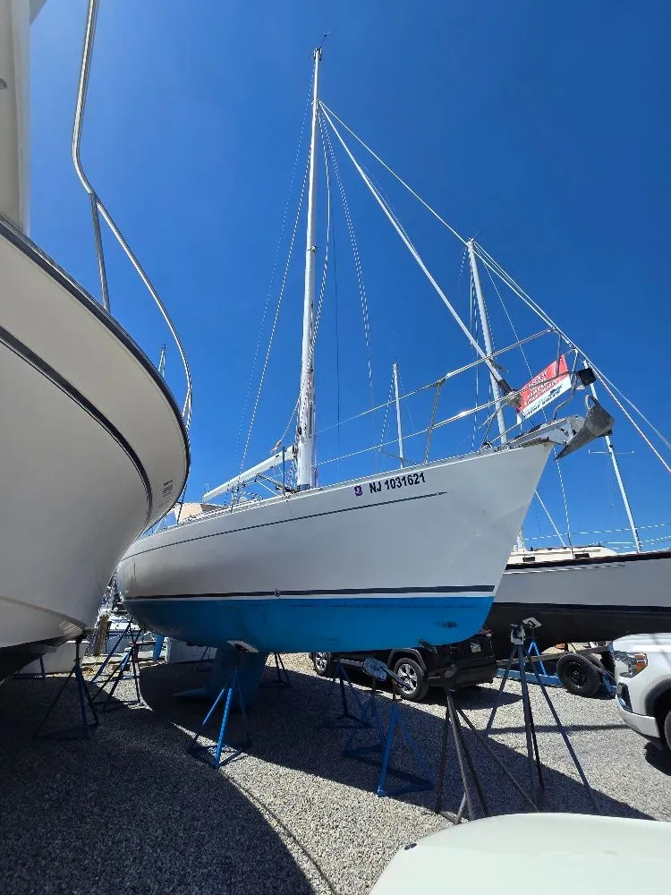 Slide: The Image of 1995 Freedom Sloop on a boat stand outdoors. - 3