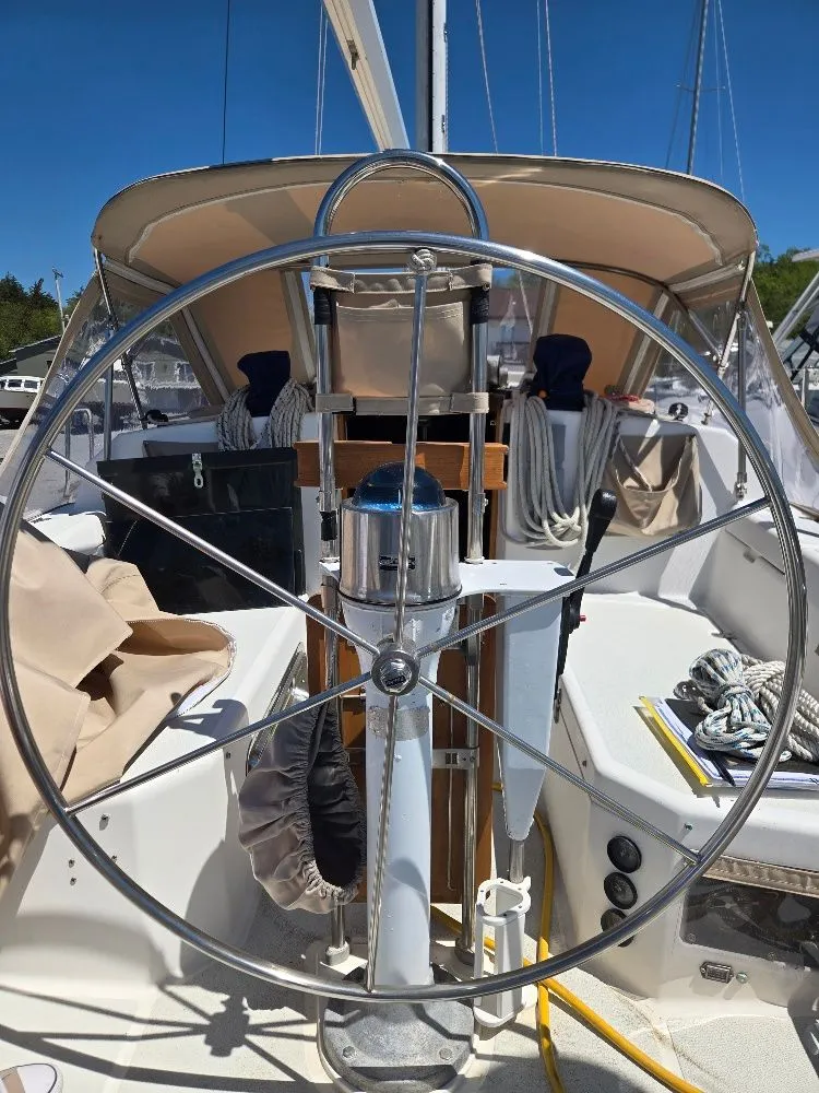 Slide: The Image of Steering wheel of a 1995 Freedom sloop in harbor. - 30