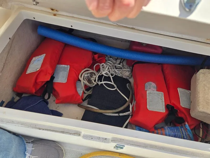 Slide: The Image of Red life jackets and ropes in a boat compartment, Freedom Sloop 1995. - 35