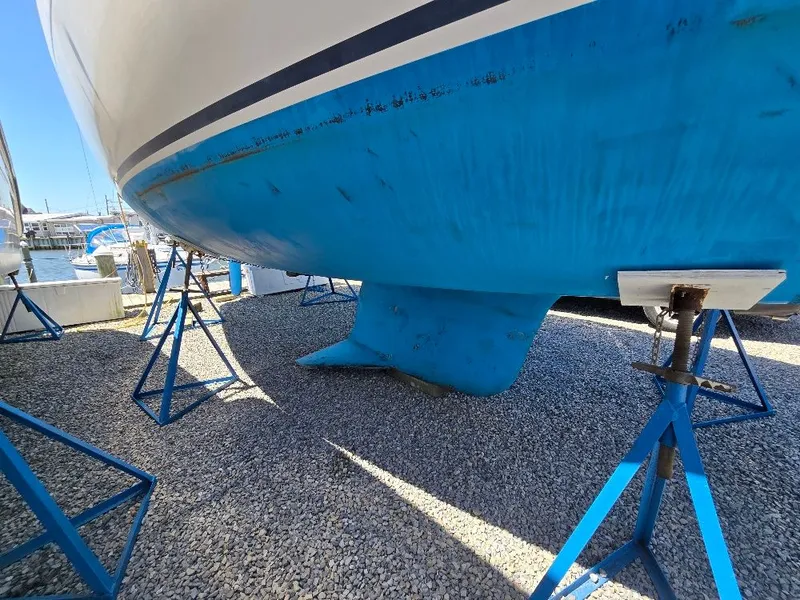 Slide: The Image of Underside of a 1995 Freedom sloop on stands in a marina. - 5