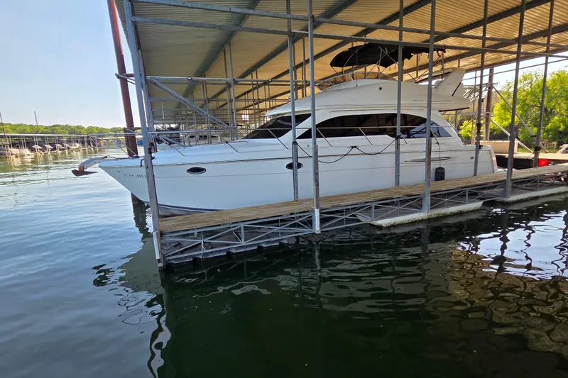 Slide: The Image of 2006 Meridian 411 Sedan yacht docked under a covered marina. - 1