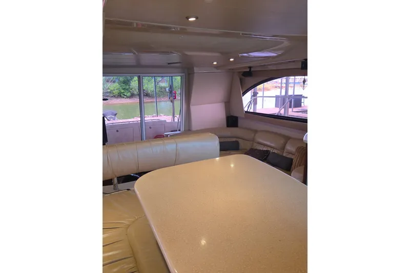 Slide: The Image of Interior of 2006 Meridian 411 Sedan yacht with beige seating and large windows. - 10