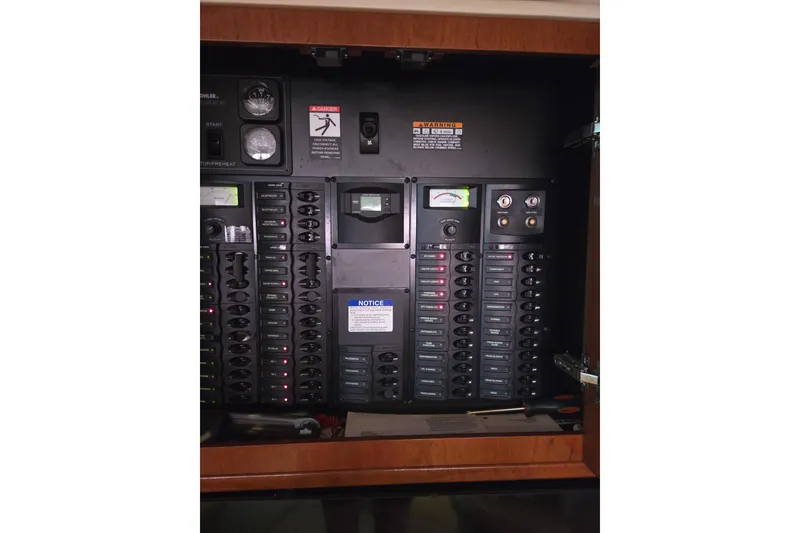 Slide: The Image of Electrical panel inside a 2006 Meridian 411 Sedan boat, featuring various switches and gauges. - 11