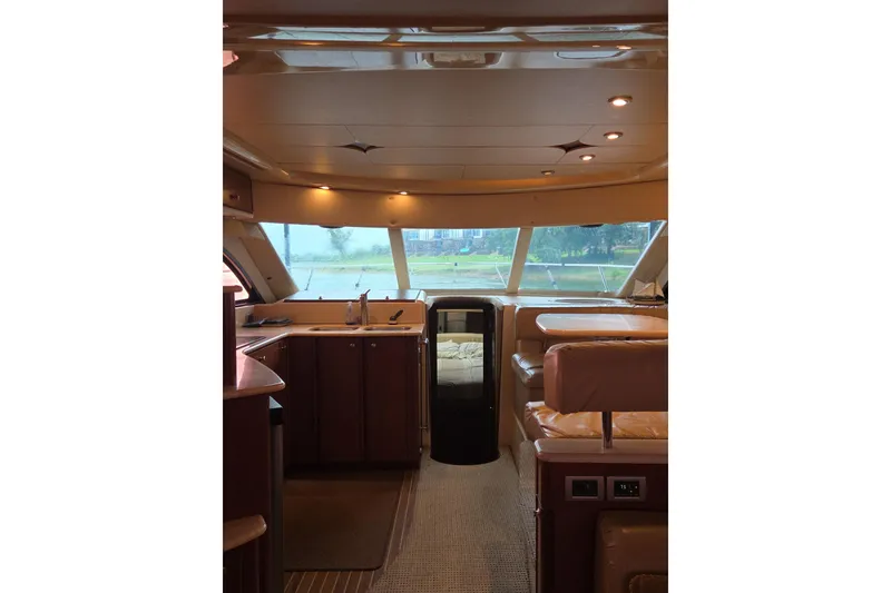 Slide: The Image of Interior of 2006 Meridian 411 Sedan yacht with luxurious seating and panoramic windows. - 12