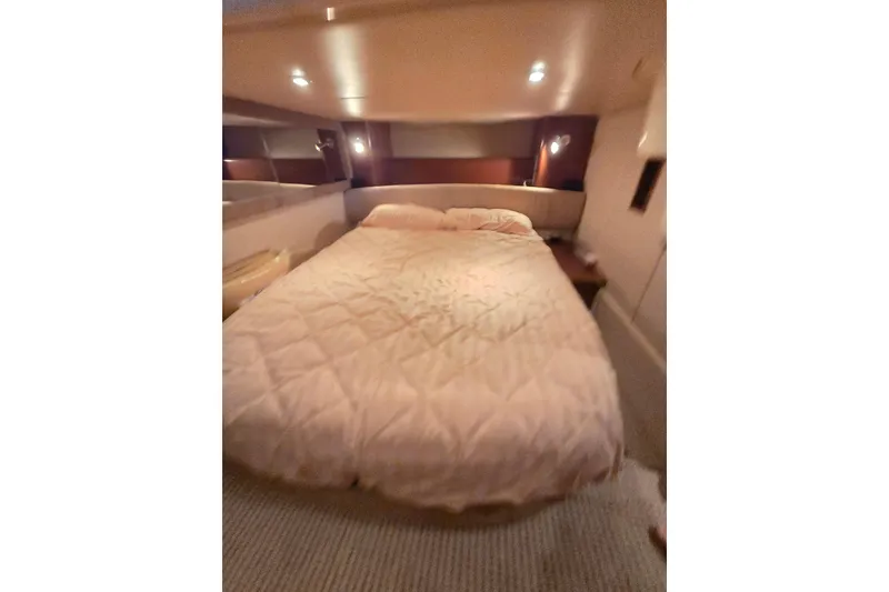 Slide: The Image of Luxurious bedroom interior of 2006 Meridian 411 Sedan yacht with cozy bedding. - 14