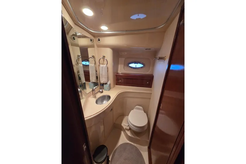 Slide: The Image of Luxurious bathroom in 2006 Meridian 411 Sedan yacht, featuring modern fixtures and elegant design. - 16
