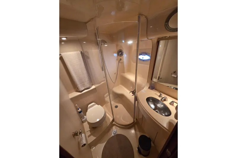 Slide: The Image of Bathroom interior of 2006 Meridian 411 Sedan yacht, featuring shower, sink, and toilet. - 17