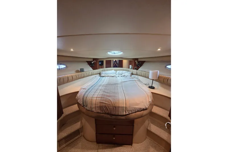 Slide: The Image of Luxurious bedroom interior of 2006 Meridian 411 Sedan yacht with cozy bedding and ambient lighting. - 18