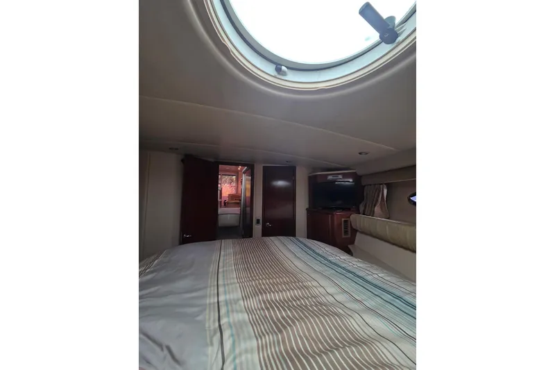 Slide: The Image of Interior cabin of 2006 Meridian 411 Sedan yacht with bed and porthole view. - 19