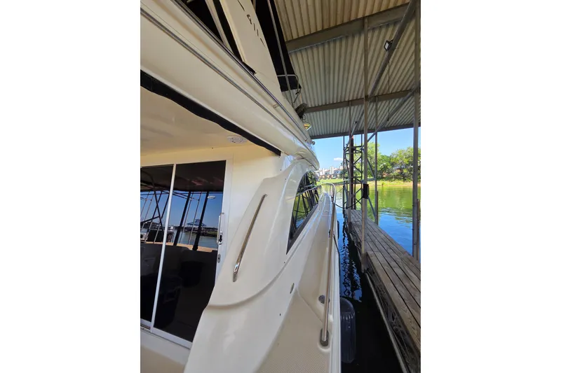 Slide: The Image of 2006 Meridian 411 Sedan yacht docked under a covered marina, side view. - 25