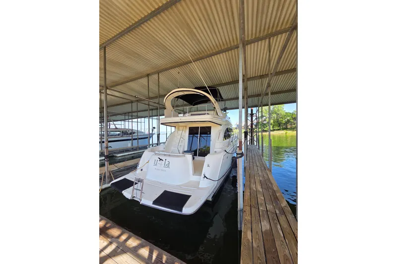 Slide: The Image of 2006 Meridian 411 Sedan yacht docked under a covered marina. - 4