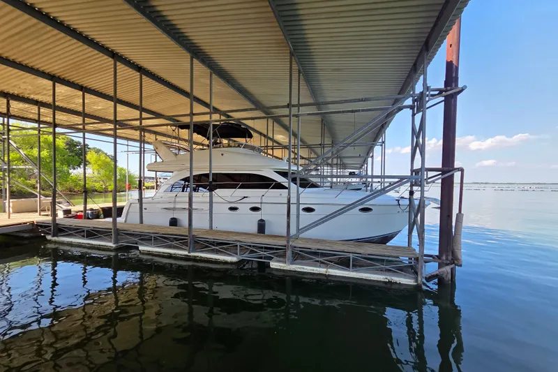 Slide: The Image of 2006 Meridian 411 Sedan yacht docked under a covered marina on a sunny day. - 5