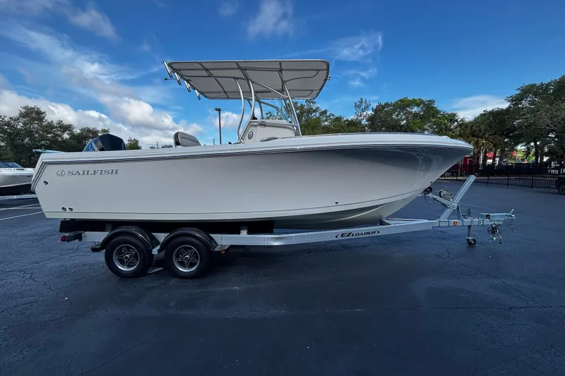 The Image of 2022 Sailfish 242 CC boat on trailer under clear blue sky. - 1