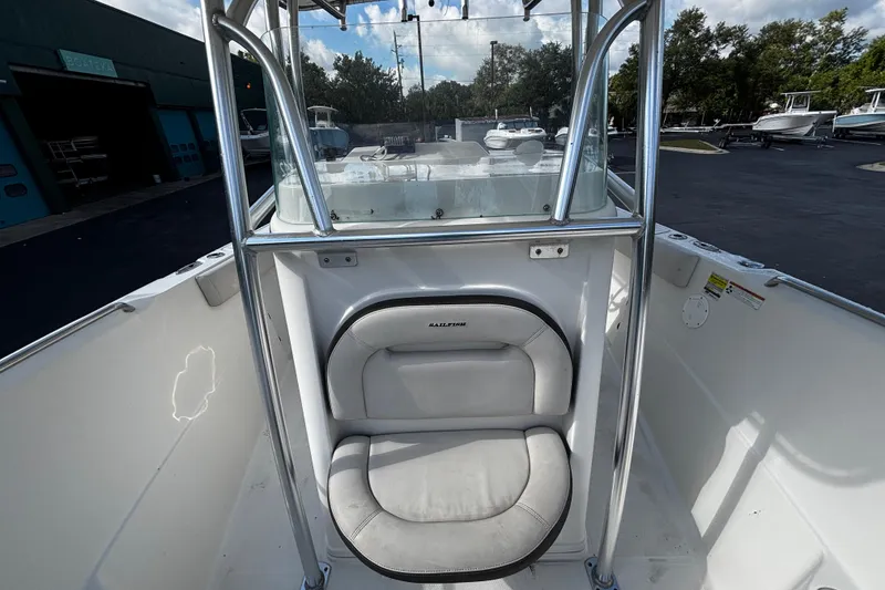 Slide: The Image of 2022 Sailfish 242 CC boat interior with cushioned seating and stainless steel frame. - 10