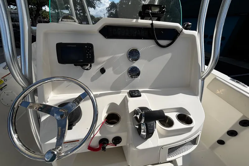 Slide: The Image of Center console of 2022 Sailfish 242 CC boat with steering wheel and controls. - 5