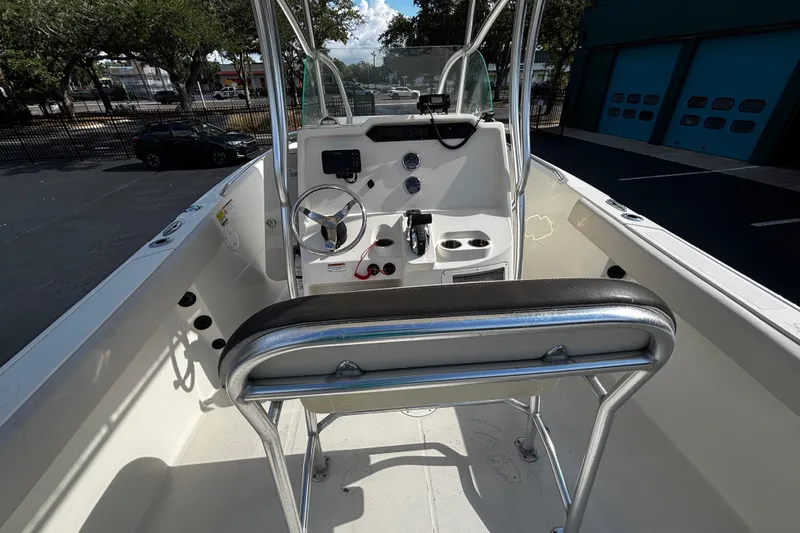 Slide: The Image of 2022 Sailfish 242 CC boat interior with steering wheel and control panel. - 6