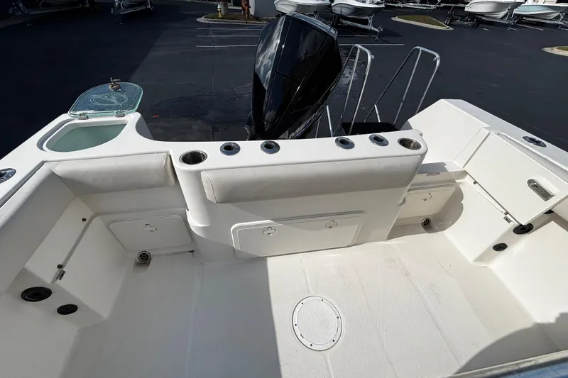 Slide: The Image of 2022 Sailfish 242 CC boat interior with seating, rod holders, and storage compartments. - 7