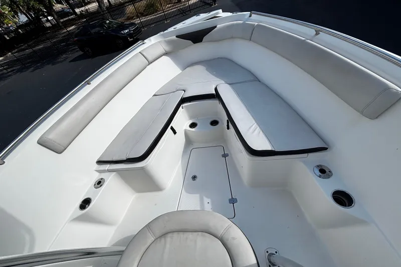 Slide: The Image of 2022 Sailfish 242 CC boat interior with cushioned seating and cup holders. - 8