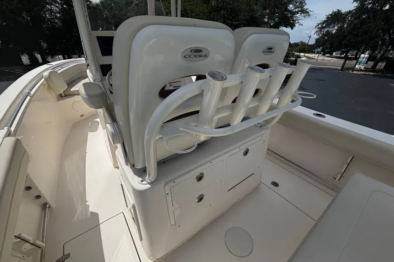 Slide: The Image of 2023 Cobia 262 Center Console boat interior with rod holders and seating. - 7