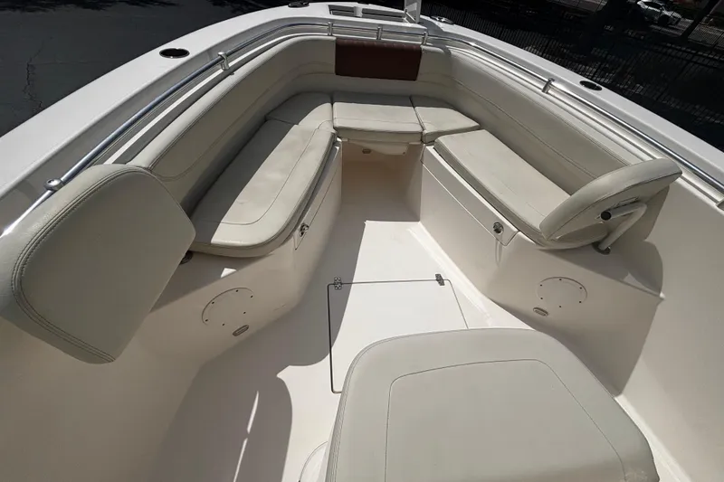 Slide: The Image of 2023 Cobia 262 Center Console boat interior with cushioned seating and storage compartments. - 8