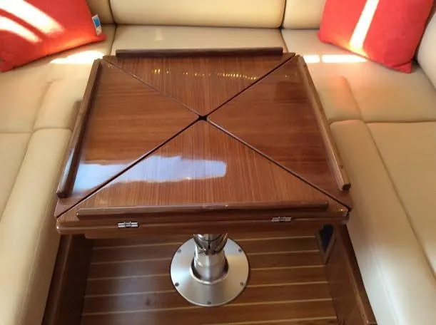 Slide: The Image of Luxurious Catalina 426 yacht interior with elegant wooden table, beige seating, and red cushions, 2026 model. - 15