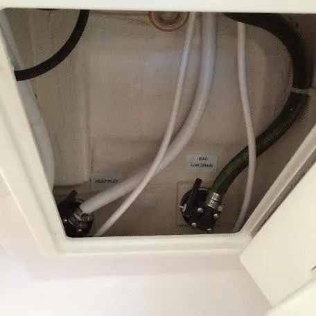 Slide: The Image of Plumbing system inside Catalina 426, 2026 model, showing head inlet and tank drain connections. - 23