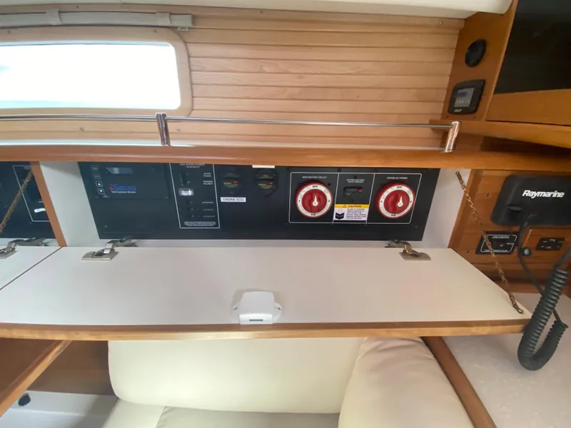 Slide: The Image of Control panel inside a 2026 Catalina 426 yacht, featuring navigation and electrical systems. - 27