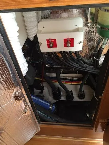 Slide: The Image of Engine compartment of a 2026 Catalina 426 boat, featuring wiring and control switches. - 43